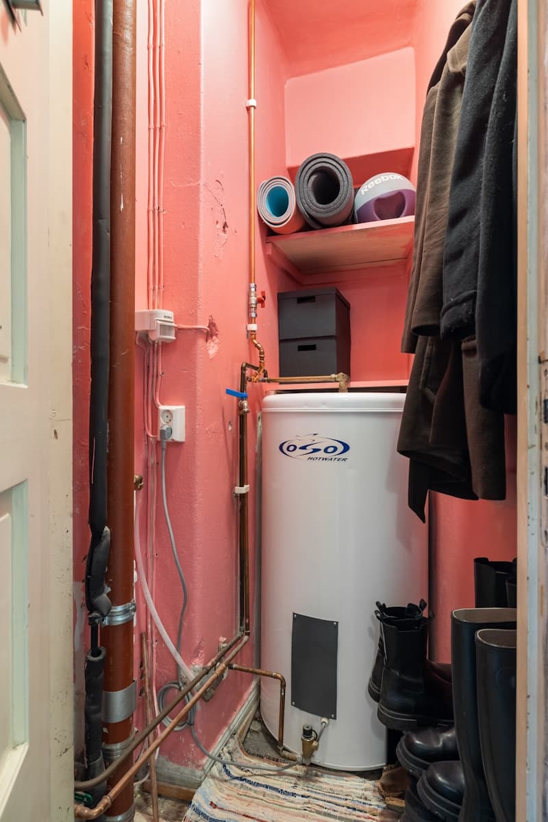 Professional water heater installation in a residential utility area